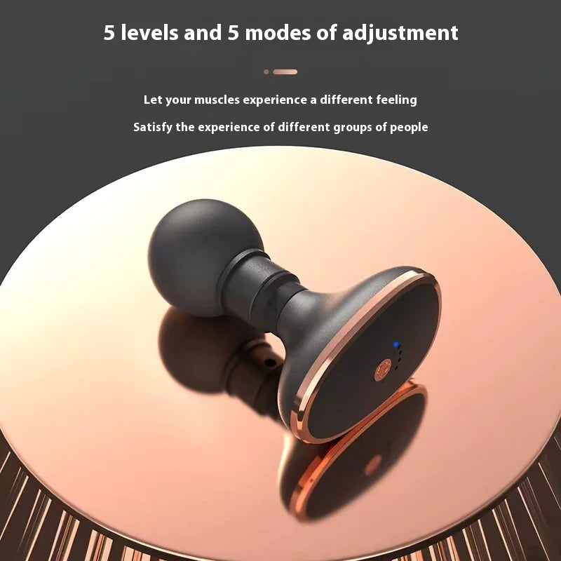 Black mini percussion muscle massager on a reflective surface with text about adjustment levels and modes.