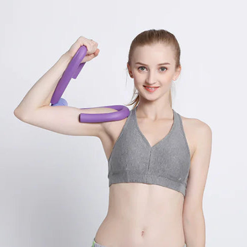 Woman using a purple portable thigh resistance trainer.