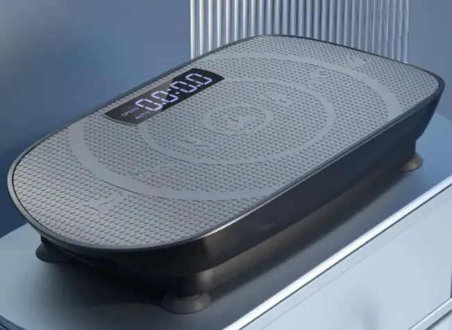 Black vibration plate with a digital display on a reflective surface.