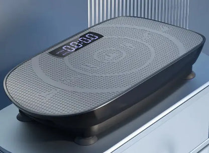 Black vibration plate with a digital display on a reflective surface.