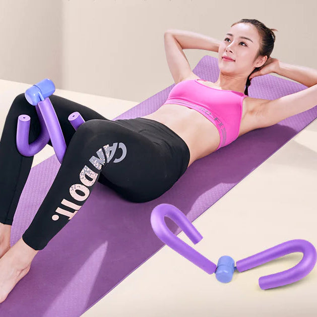 Woman exercising on a purple mat with a purple portable thigh resistance trainer.