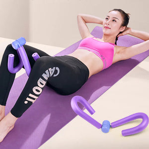 Woman exercising on a purple mat with a purple portable thigh resistance trainer.