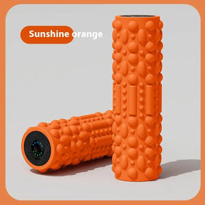 Orange foam roller with textured surface on a light gray background.