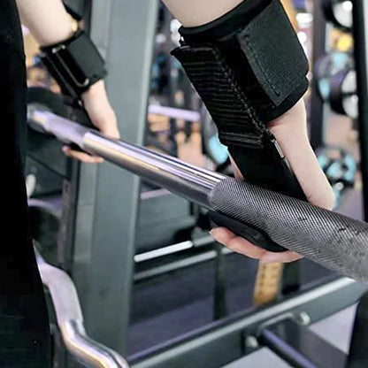Person pulling a weightlifting bar with weight-lifting hooks with wrist straps in a gym.