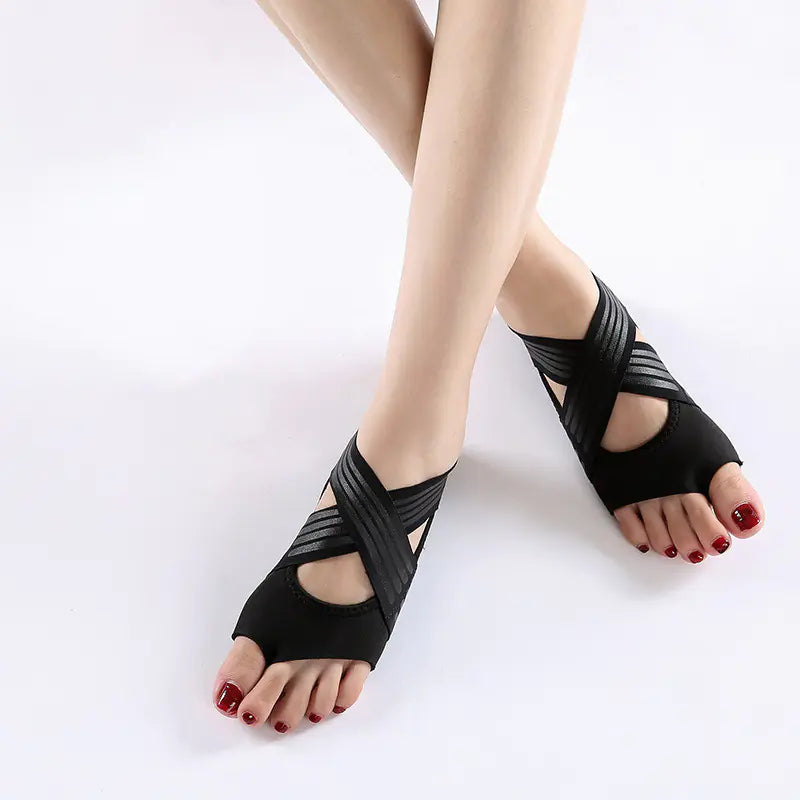Women's black non-slip yoga shoes with soft flexible sole for indoor fitness and studio training.