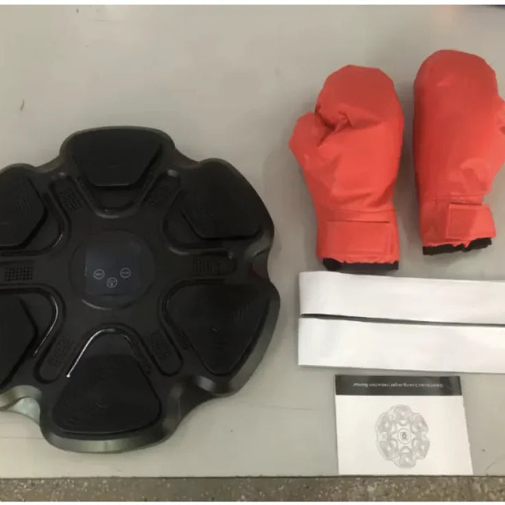 Black smart boxing wall target with adults gloves for reaction training and home fitness workouts.