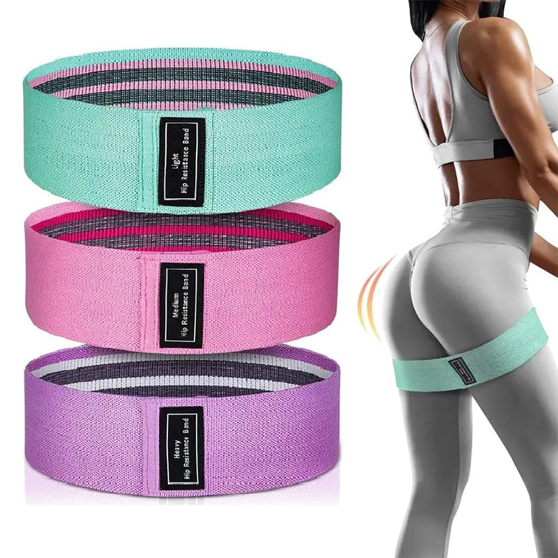 Three fabric resistance bands in green, pink, and purple with a person wearing gray leggings and sports bra.