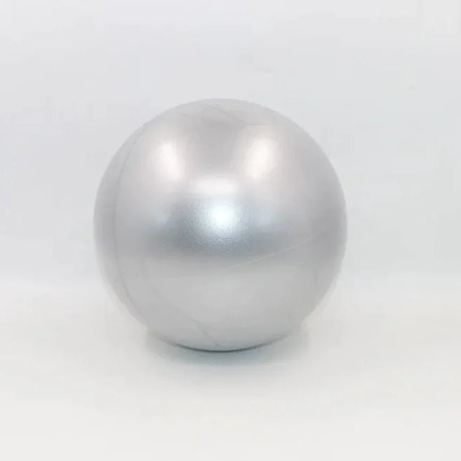 Grey colored portable pilates mini ball for core strengthening, balance training, and yoga exercises.