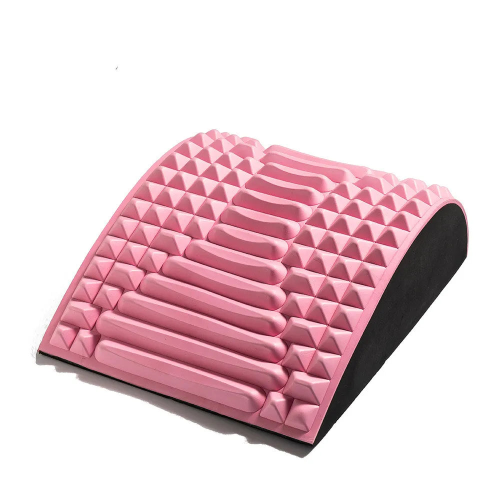 Contoured pink colored yoga pillow with ergonomic design for waist and lower-back support during stretching.