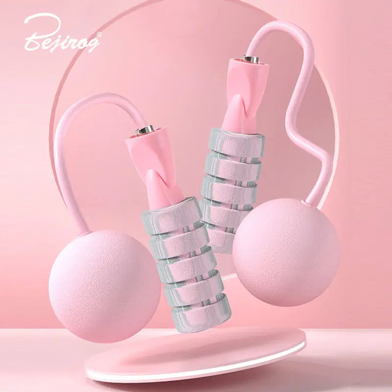 Close-up of pink colored weighted handles on dual-use jump rope for added resistance and arm toning.