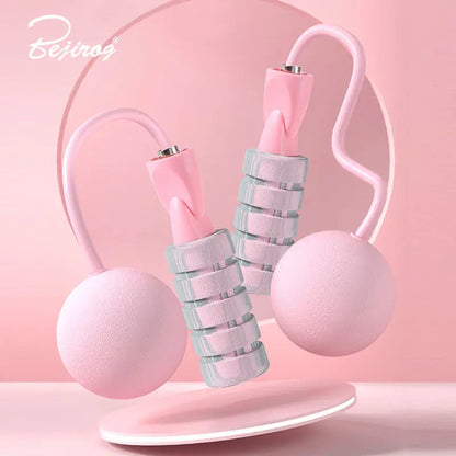 Close-up of pink colored weighted handles on dual-use jump rope for added resistance and arm toning.