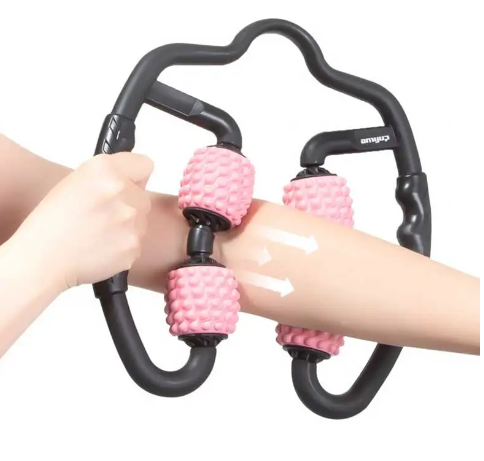 Person using a pink foam massage roller on their arm against a white background.