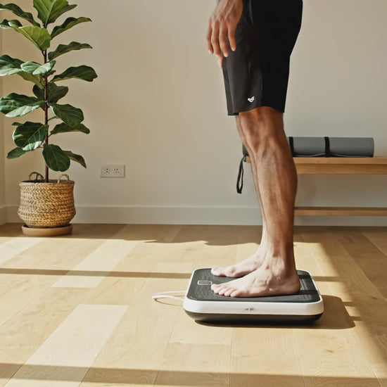 Man on Vibration Plate for Low-Impact Home Workouts.