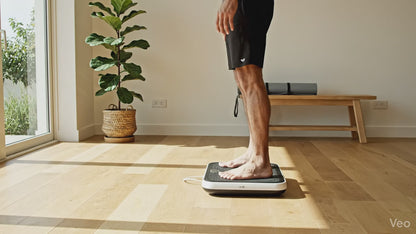 Man on Vibration Plate for Low-Impact Home Workouts.