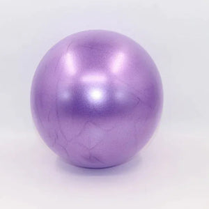 Purple colored portable pilates mini ball for core strengthening, balance training, and yoga exercises.