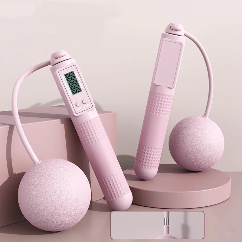 Smart jump rope with big pink balls and digital display on a light blue background.