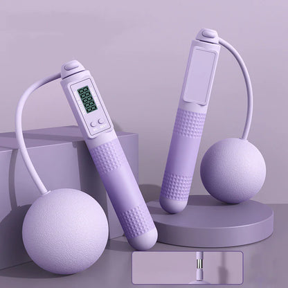 Smart jump rope with big purple balls and digital display on a light blue background.